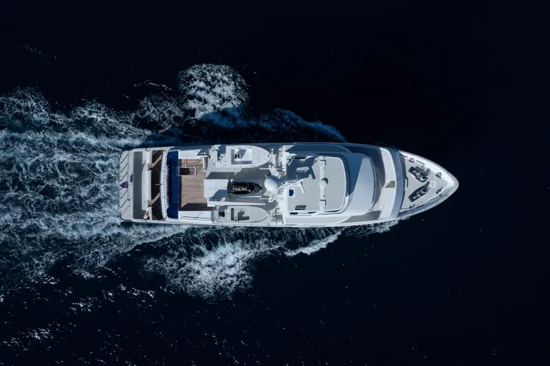 Penelope Yacht Photos Pics Aerial view of 1990 Delta Expedition yacht cruising through dark blue ocean waters.