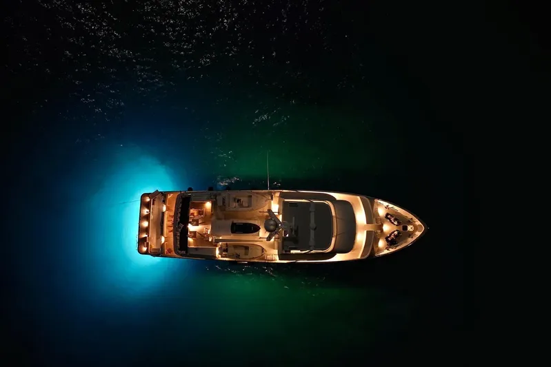 Penelope Yacht Photos Pics Aerial view of illuminated 1990 Delta Expedition yacht on dark water.