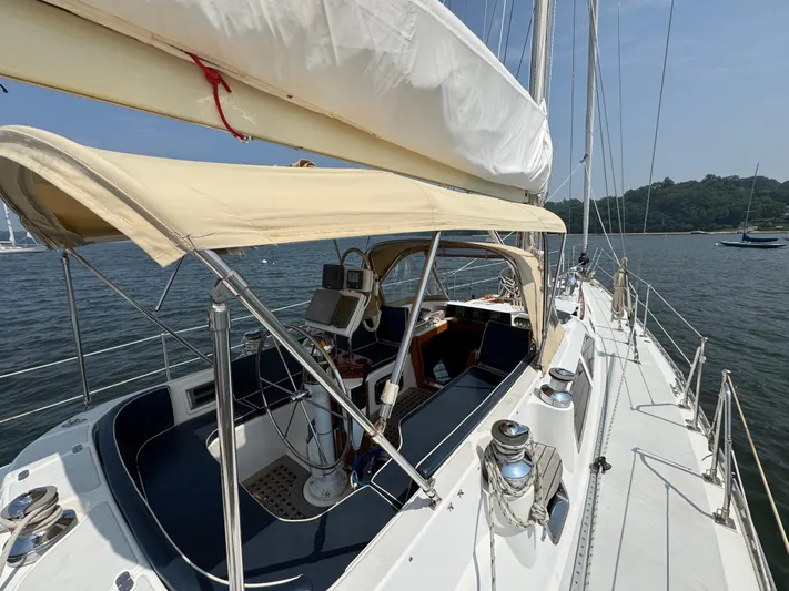 Elena Yacht Photos Pics Sailing yacht Hylas 46, 1998 model, with spacious cockpit and canopy on calm waters.