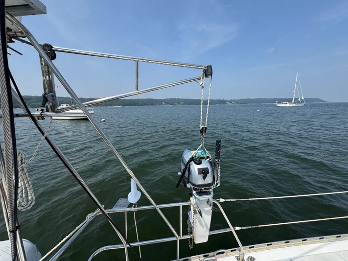 Elena Yacht Photos Pics Sailboat deck view with motor hoist, Hylas 46, 1998, on calm waters.