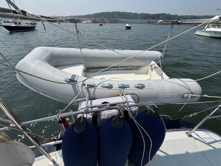 Elena Yacht Photos Pics Inflatable dinghy on a 1998 Hylas 46 yacht, moored in a scenic harbor.