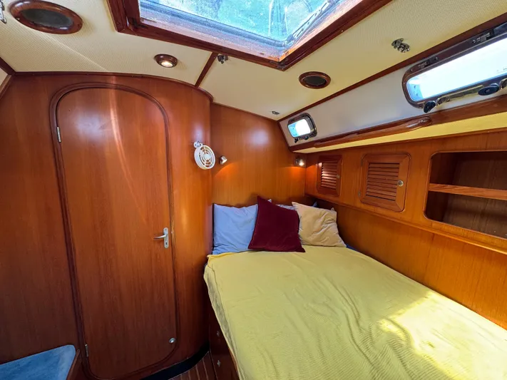 Elena Yacht Photos Pics Cozy cabin interior of a 1998 Hylas 46 yacht with wooden finishes and skylight.