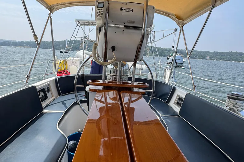 Elena Yacht Photos Pics Sailboat cockpit view, Hylas 46, 1998 model, with wooden table and navigation equipment.