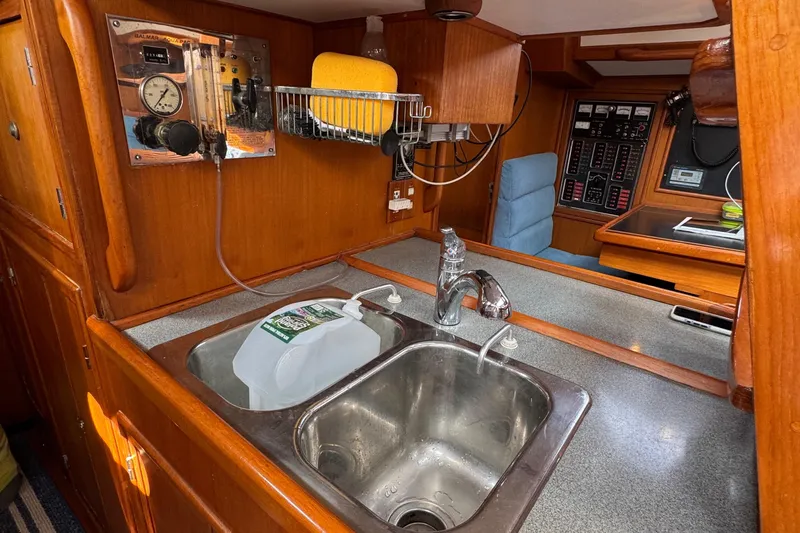 Elena Yacht Photos Pics Interior of 1998 Hylas 46 yacht kitchen with sink and control panel.