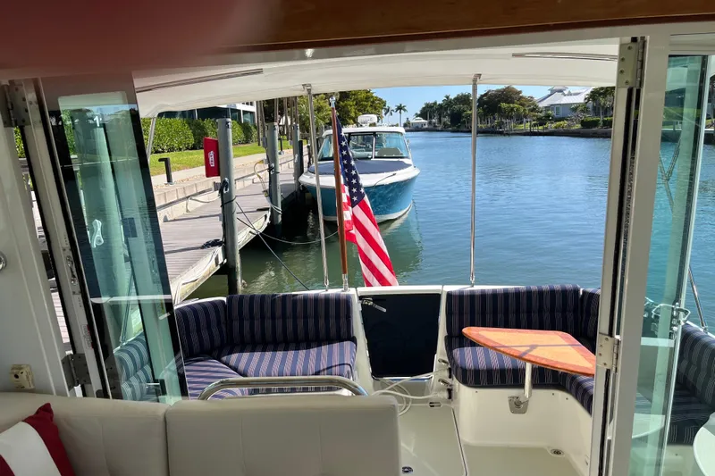 Phalarope Yacht Photos Pics Interior view of 2017 Back Cove 37 yacht with American flag and waterfront scenery.