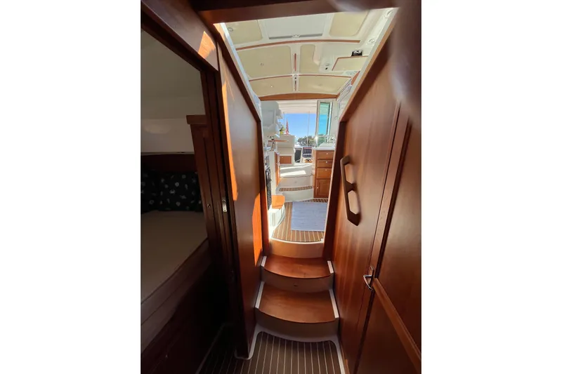 Phalarope Yacht Photos Pics Interior view of 2017 Back Cove 37 yacht, featuring wooden stairs and cabin entrance.
