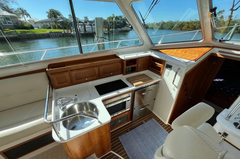 Phalarope Yacht Photos Pics Luxurious 2017 Back Cove 37 yacht interior with modern kitchen and scenic water view.