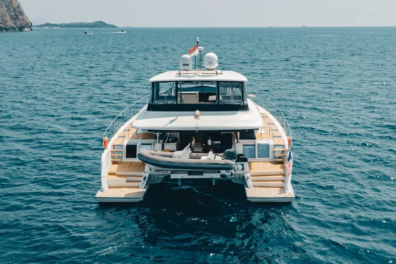  Yacht Photos Pics Lagoon 630 Motor Yacht 2017 cruising on open sea, rear view.