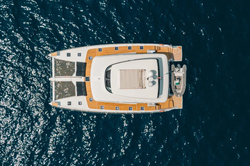  Yacht Photos Pics Overhead view of 2017 Lagoon 630 Motor Yacht on sparkling blue water.
