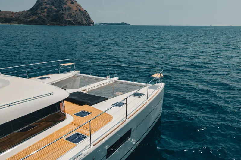  Yacht Photos Pics Lagoon 630 Motor Yacht 2017 cruising on serene blue waters near a scenic island.