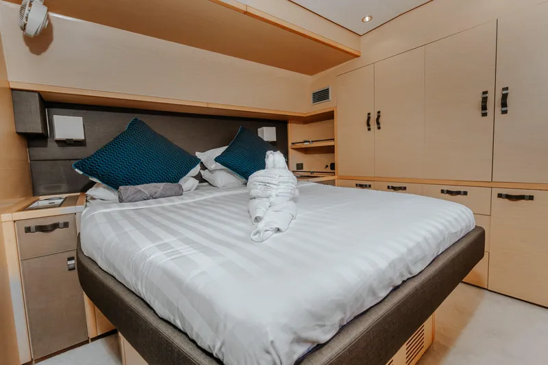  Yacht Photos Pics Luxurious bedroom interior of 2017 Lagoon 630 Motor Yacht with elegant bedding and storage.