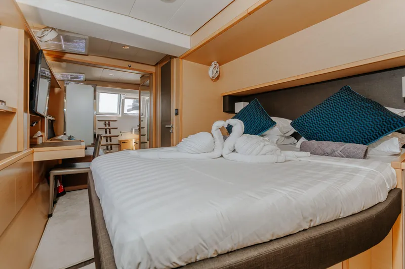  Yacht Photos Pics Luxurious bedroom interior of 2017 Lagoon 630 Motor Yacht with elegant decor and swan towel art.