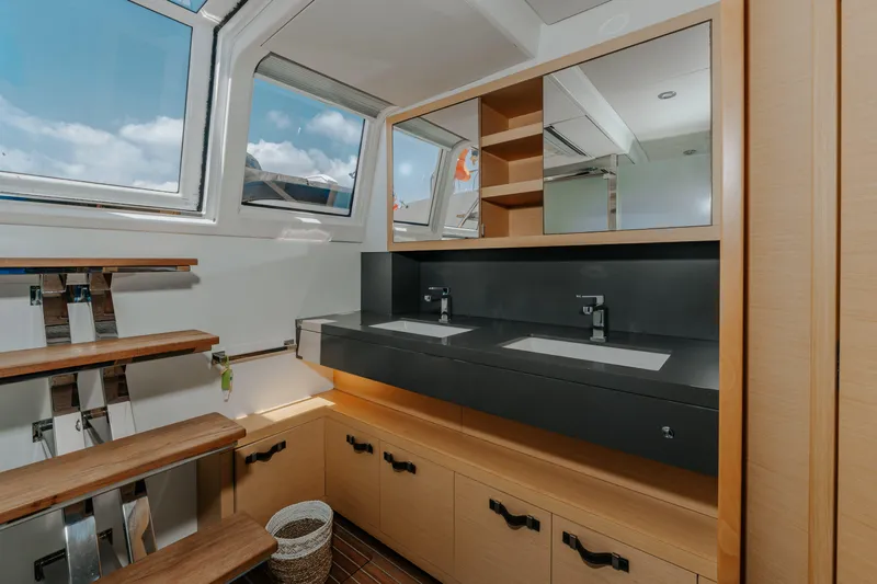  Yacht Photos Pics Luxurious bathroom interior of 2017 Lagoon 630 Motor Yacht with dual sinks and modern design.