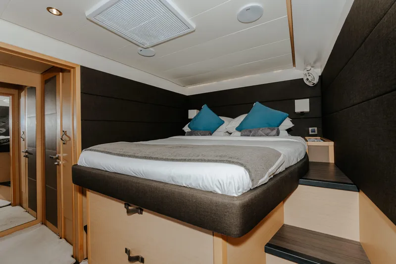  Yacht Photos Pics Luxurious bedroom interior of 2017 Lagoon 630 Motor Yacht with modern design and cozy bedding.