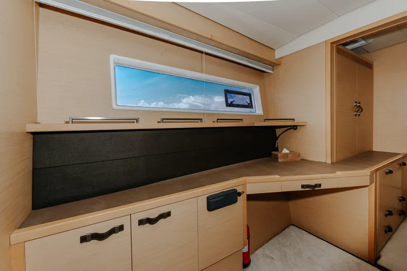  Yacht Photos Pics Luxurious interior of 2017 Lagoon 630 Motor Yacht with sleek cabinetry and ocean view window.