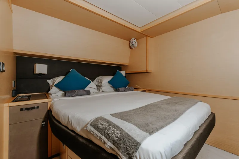  Yacht Photos Pics Luxurious bedroom interior of 2017 Lagoon 630 Motor Yacht with modern design and cozy bedding.