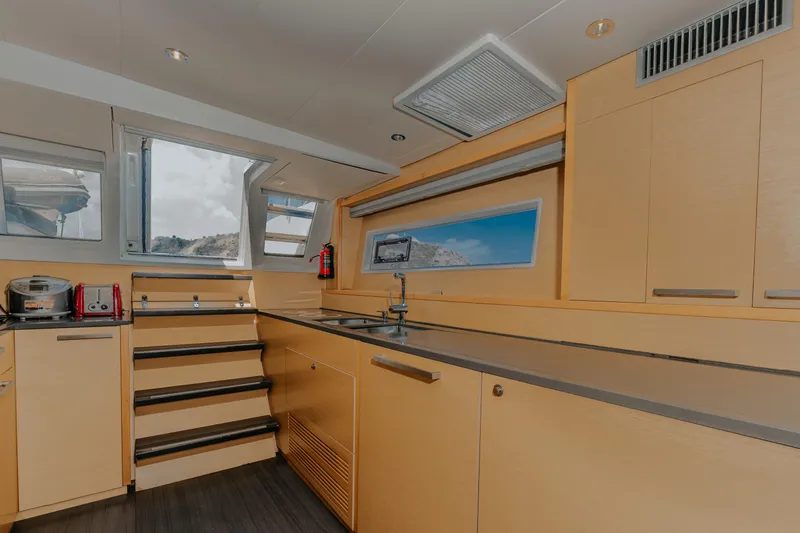  Yacht Photos Pics Modern kitchen interior of 2017 Lagoon 630 Motor Yacht with sleek cabinetry and appliances.