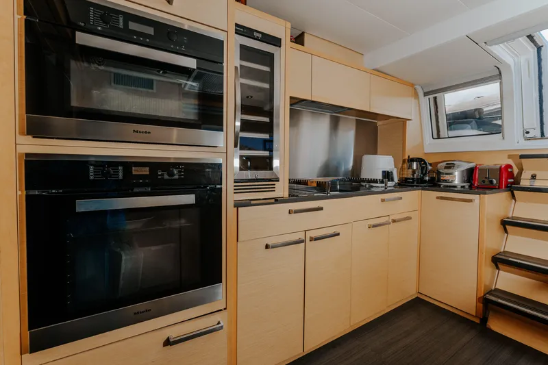  Yacht Photos Pics Modern kitchen in 2017 Lagoon 630 Motor Yacht with appliances and wooden cabinetry.