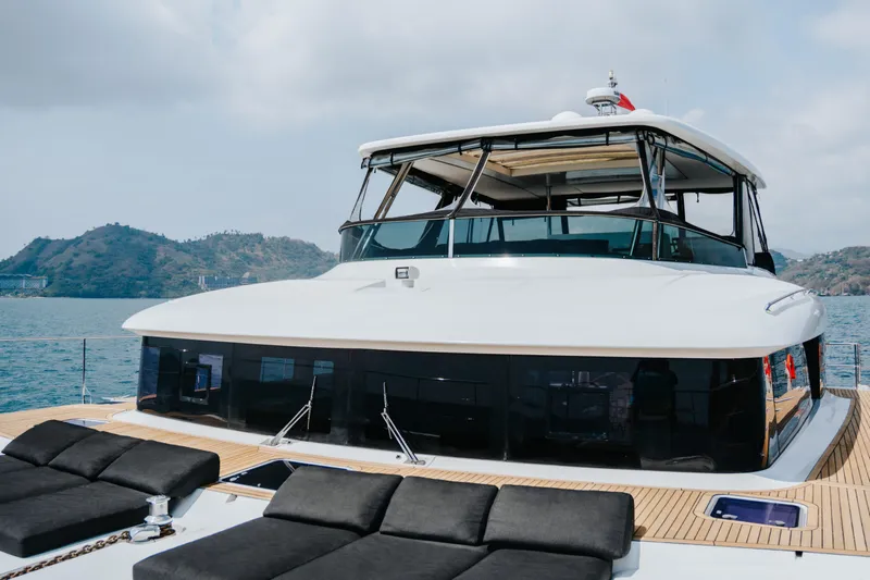  Yacht Photos Pics Luxurious 2017 Lagoon 630 Motor Yacht on serene waters with scenic mountain backdrop.