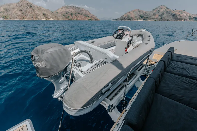  Yacht Photos Pics 2017 Lagoon 630 Motor Yacht with tender, anchored near scenic islands.