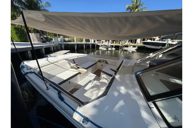  Yacht Photos Pics 2021 World Cat 400 DC-X boat with shaded seating area docked by the water.