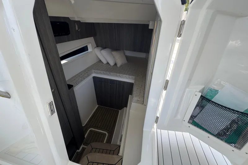  Yacht Photos Pics Interior cabin of 2021 World Cat 400 DC-X boat, featuring cozy bedding and modern design.