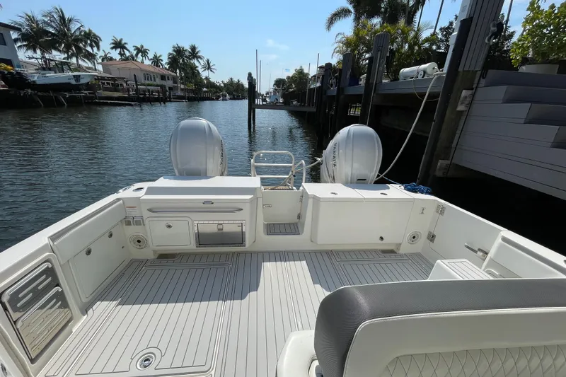  Yacht Photos Pics World Cat 400 DC-X 2021 boat deck with dual engines, docked in a scenic canal.