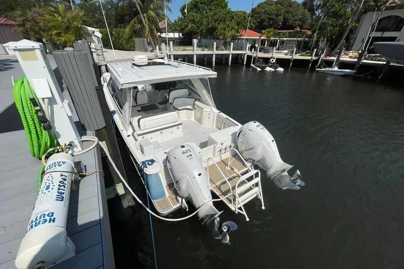  Yacht Photos Pics 2021 World Cat 400 DC-X boat docked with twin engines, in a serene marina setting.