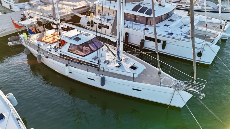  Yacht Photos Pics Sailing yacht Amel 55, 2011 model, docked at marina with nearby catamarans.