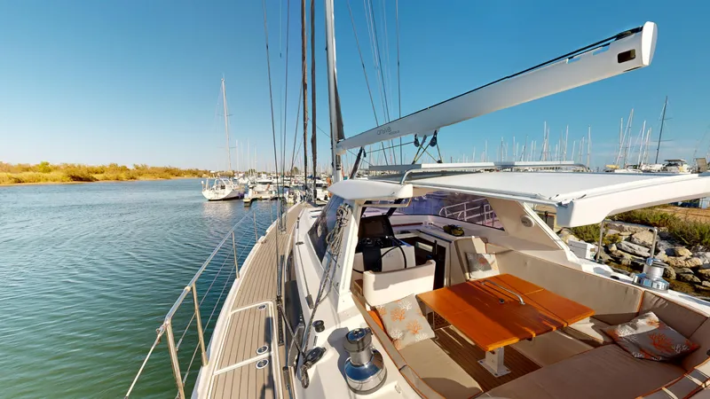  Yacht Photos Pics Luxurious 2011 Amel 55 yacht with spacious deck and seating, docked in a serene marina.