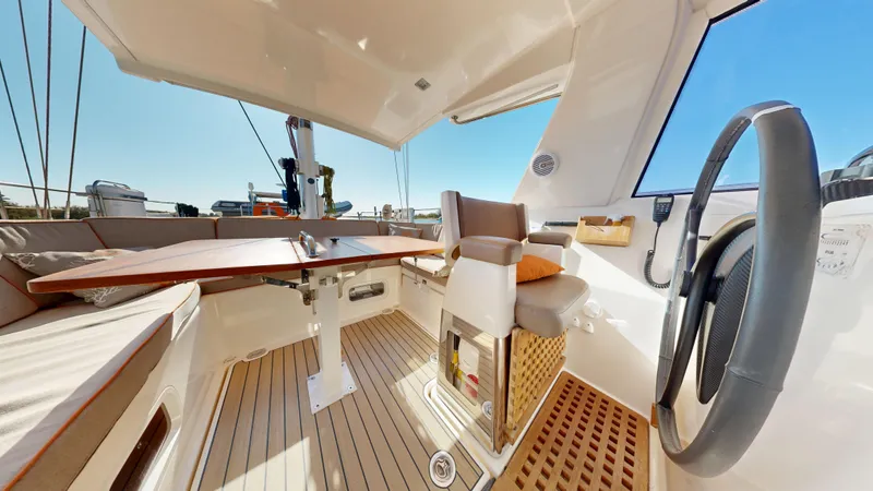  Yacht Photos Pics Luxurious 2011 Amel 55 yacht cockpit with steering wheel, seating, and wooden table.