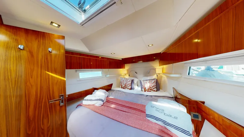  Yacht Photos Pics Luxurious cabin interior of 2011 Amel 55 yacht with wood paneling and skylight.