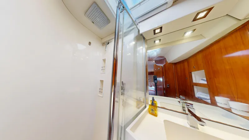  Yacht Photos Pics Luxurious bathroom interior of 2011 Amel 55 yacht with modern fixtures and wooden accents.