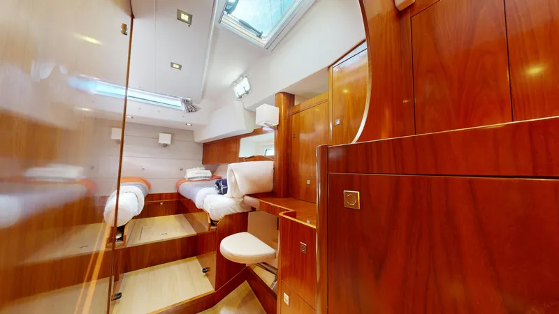  Yacht Photos Pics Luxurious interior of 2011 Amel 55 yacht with wooden finishes and twin beds.