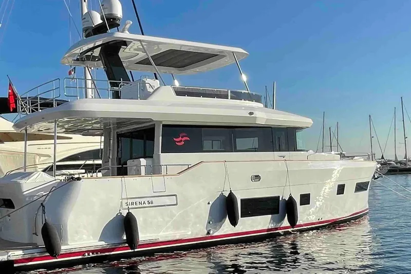  Yacht Photos Pics 2022 Sirena 58 yacht docked at marina, sleek design, sunny day, calm waters.