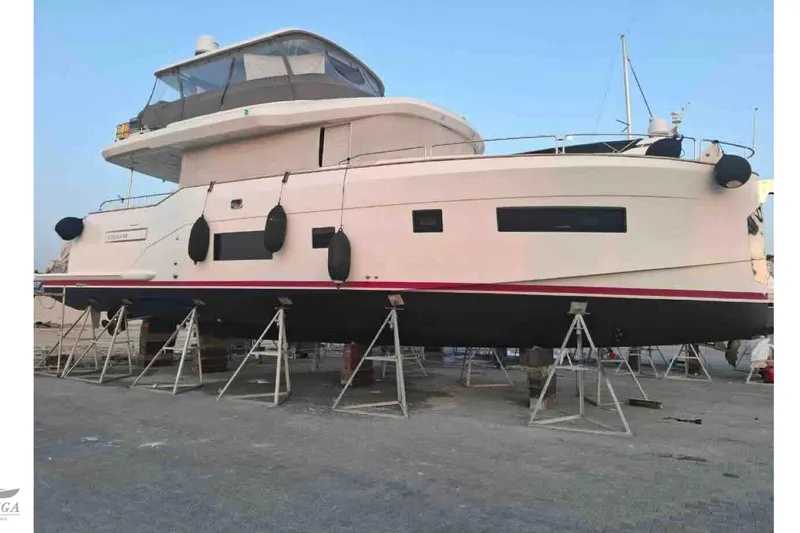  Yacht Photos Pics 2022 Sirena 58 yacht on stands, side view, in a shipyard setting.
