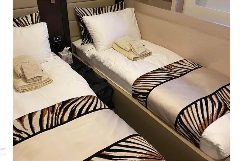  Yacht Photos Pics Luxurious twin beds with zebra-patterned bedding on a 2022 Sirena 58 yacht.