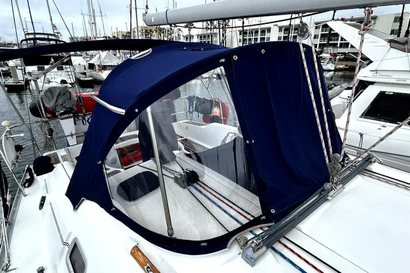 Notos Yacht Photos Pics 2005 Beneteau Oceanis 373 sailboat with blue canopy in marina setting.