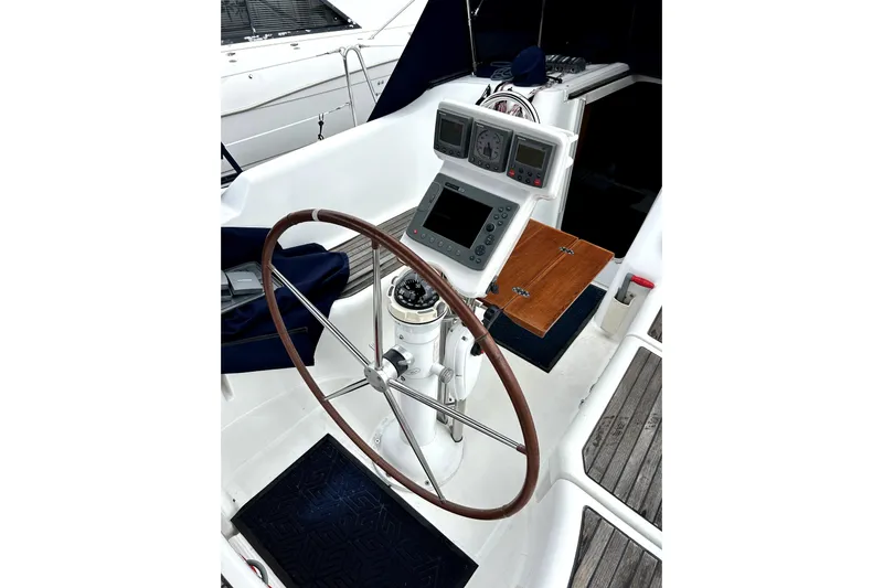 Notos Yacht Photos Pics Cockpit of 2005 Beneteau Oceanis 373 sailboat with steering wheel and navigation instruments.