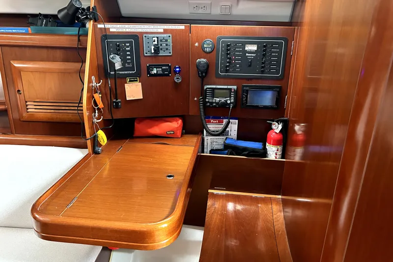 Notos Yacht Photos Pics Navigation station of 2005 Beneteau Oceanis 373 yacht with control panels and equipment.