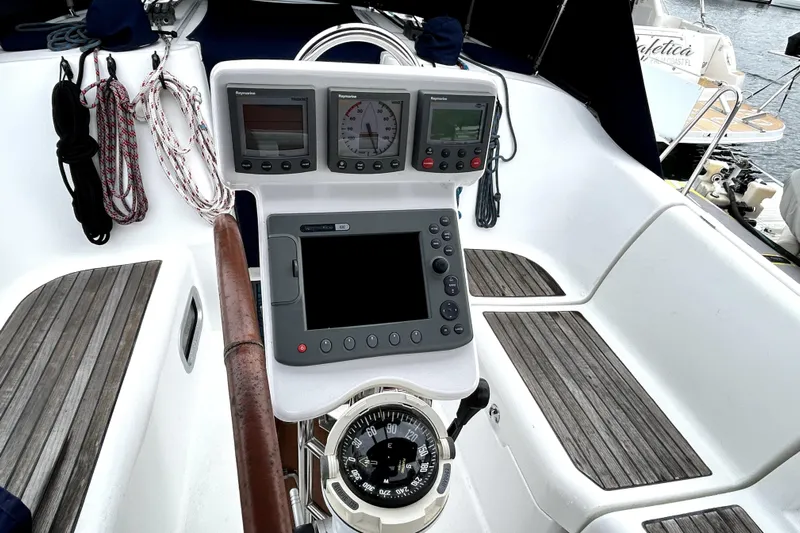 Notos Yacht Photos Pics Cockpit of 2005 Beneteau Oceanis 373 sailboat with navigation instruments and compass.