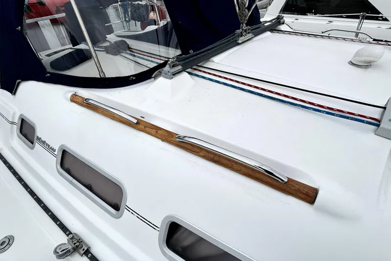 Notos Yacht Photos Pics 2005 Beneteau Oceanis 373 sailboat deck with wood and metal handrail.