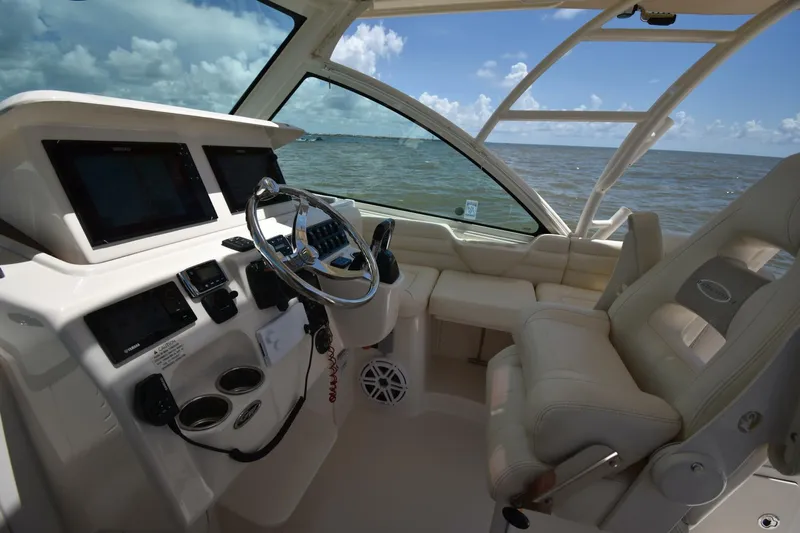 Policy Maker Yacht Photos Pics 2016 Grady-White Express 330 helm with dual displays, steering wheel, and ocean view.
