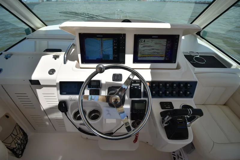 Policy Maker Yacht Photos Pics Helm of 2016 Grady-White Express 330 with dual navigation screens and steering wheel.