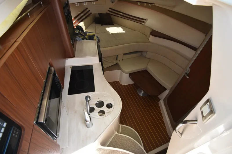 Policy Maker Yacht Photos Pics 2016 Grady-White Express 330 cabin interior with kitchenette and seating area.