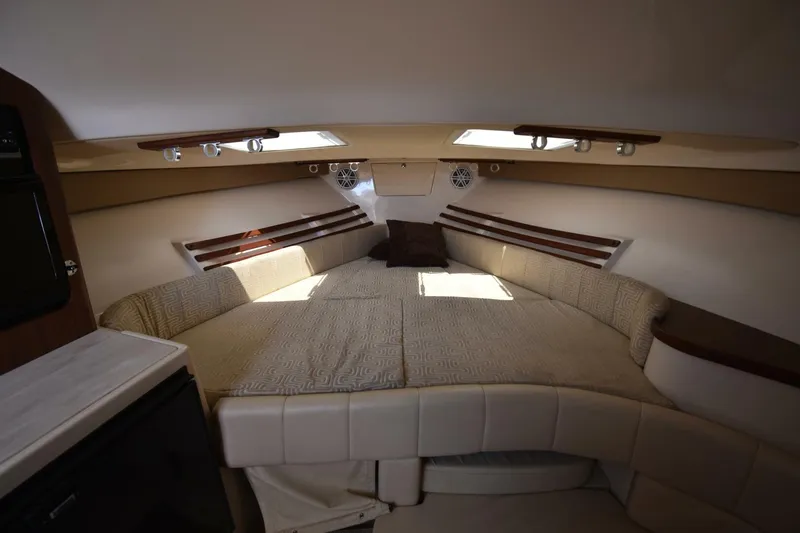 Policy Maker Yacht Photos Pics 2016 Grady-White Express 330 cabin interior with cozy bed and modern lighting.