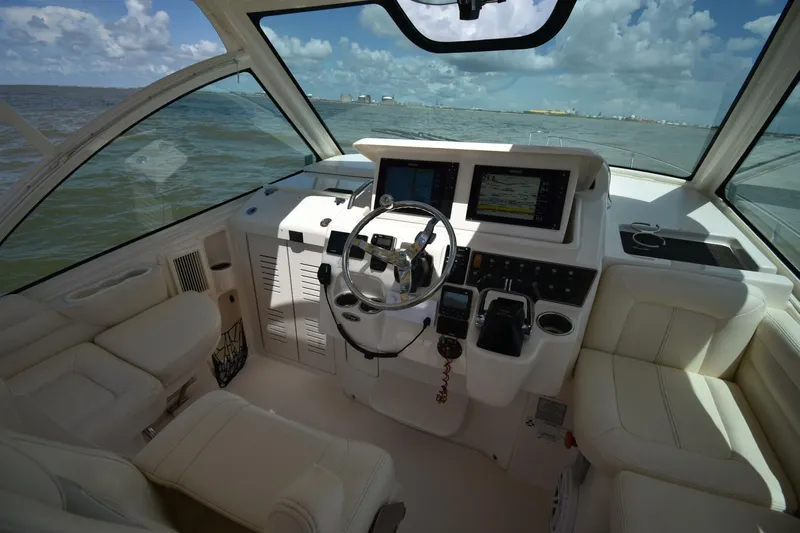 Policy Maker Yacht Photos Pics 2016 Grady-White Express 330 helm with modern navigation equipment and luxurious seating.