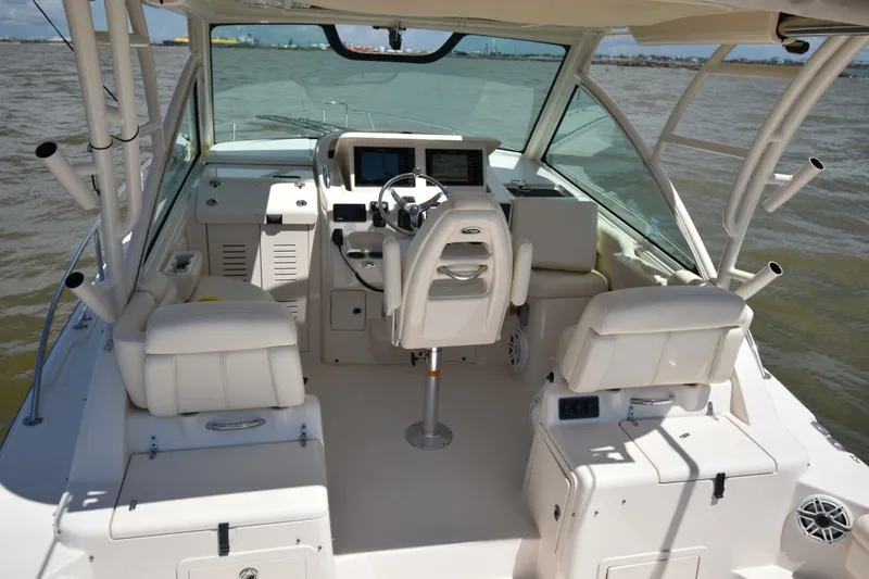 Policy Maker Yacht Photos Pics 2016 Grady-White Express 330 boat interior with helm and seating on open water.