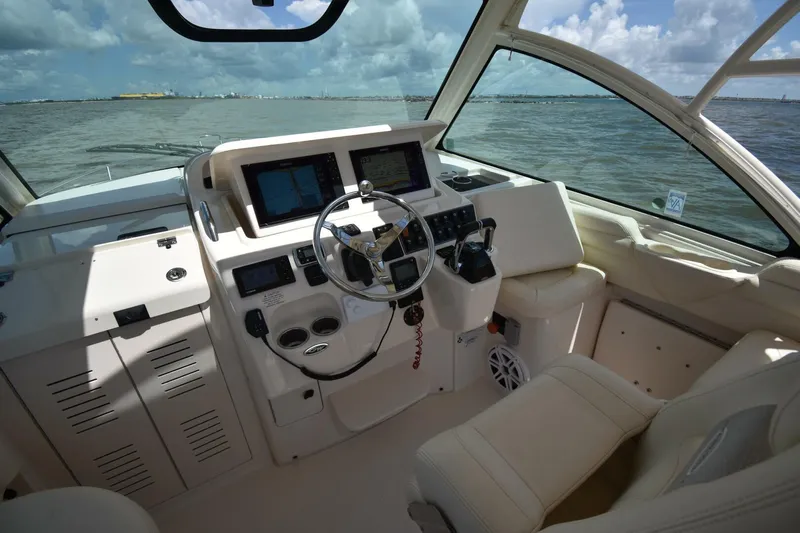 Policy Maker Yacht Photos Pics 2016 Grady-White Express 330 helm with modern navigation equipment and ocean view.