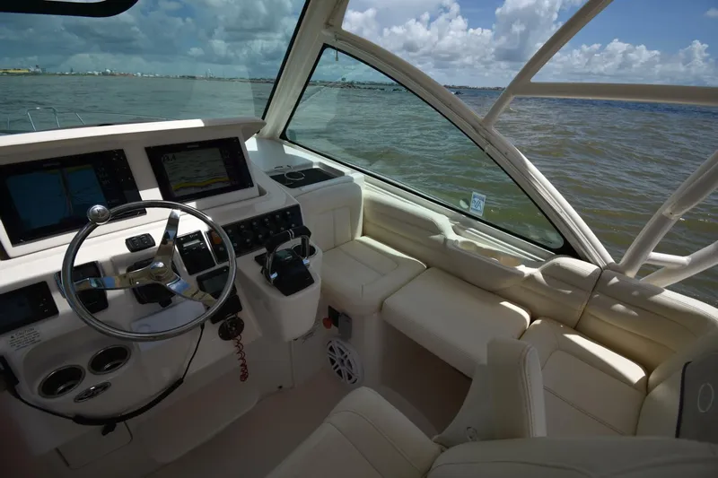 Policy Maker Yacht Photos Pics 2016 Grady-White Express 330 boat interior with steering wheel and navigation screens.